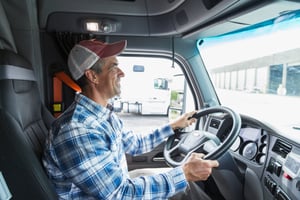 Smiling-Truck-Driver-In-Truck-Cab-3
