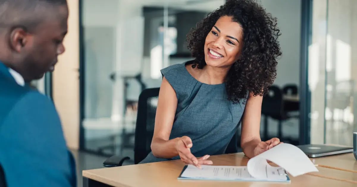 A woman insurance agent walking through an insurance coverage with a man