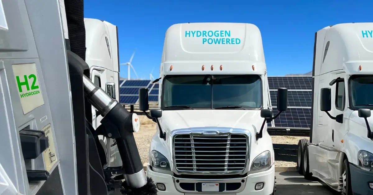 Long haul semi trucks parked at a eco-friendly refuel station for hydrogen fuel