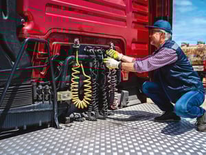 man fixing hoses
